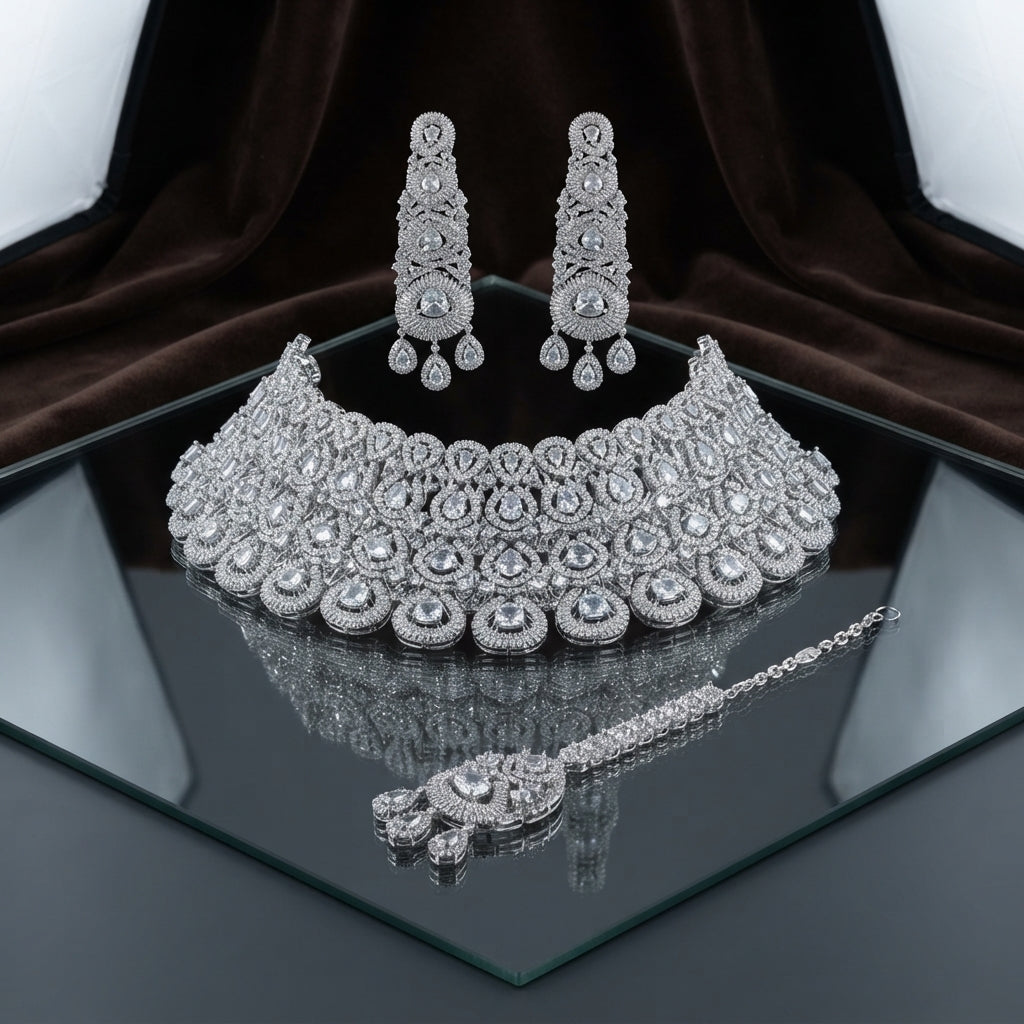 Silver White Polki CZ Grand Medallion Bib Choker Chandelier Earrings & Maang Tikka Grand Bridal Set on mirror surface with dark brown velvet and white drape backdrop