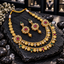 South Indian-style gold-tone double row coin necklace with clear, green and deep pink accents, floral side panels and matching floral bead-drop earrings.
