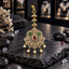 Gold-tone South Indian-style ornament with a red teardrop centre, green scroll accents, clear sparkling details and five cream pearl-look drops.