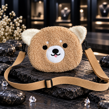 Front view of tan teddy-face crossbody bag with cream ears, white muzzle, pink tongue detail and adjustable tan strap.