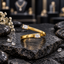 Xuping gold-tone open wrap ring with two offset clear rectangular accents, four-corner settings and fine lengthwise texture on the band.